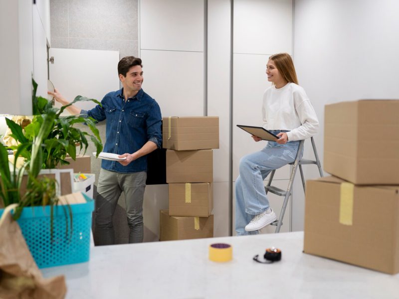 couple-unpacking-their-belongings_23-2149312726